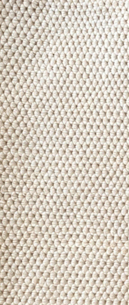 Close-up of the raised pebble texture on a beige Solyra kitchen cloth