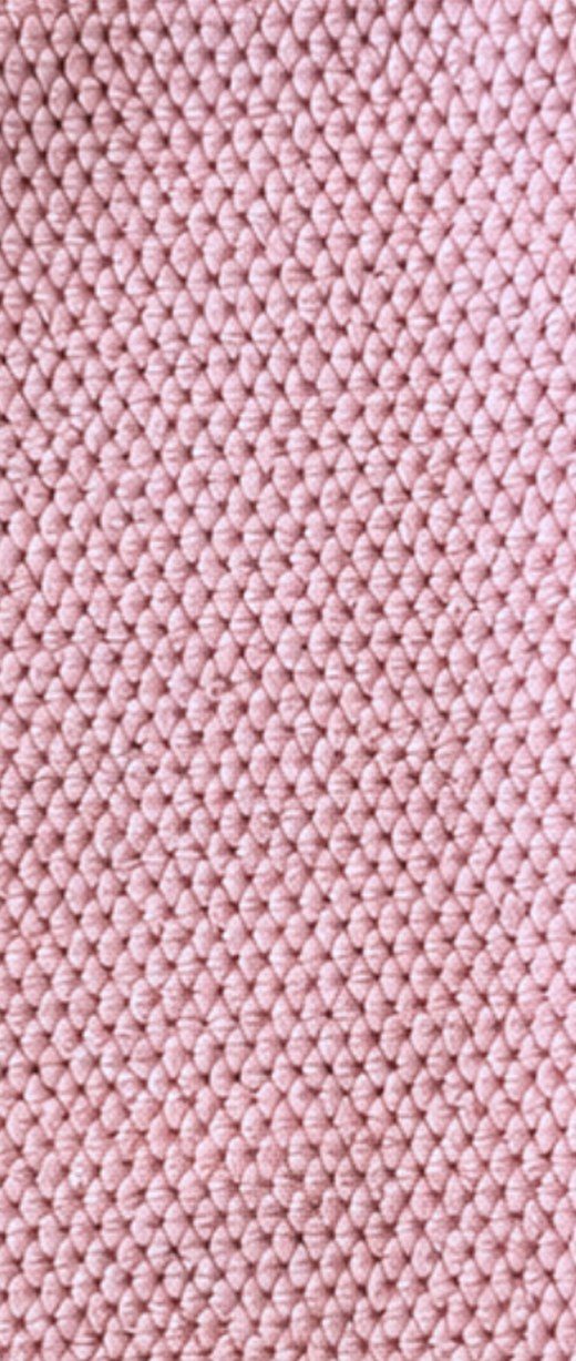 Close-up of the raised pebble texture on a pink Solyra kitchen cloth
